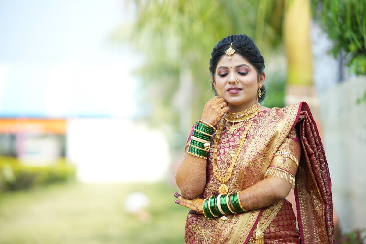 Elegant party makeover — black saree with bridal updo hairstyle by Shrungar Beauty Parlour Ravet